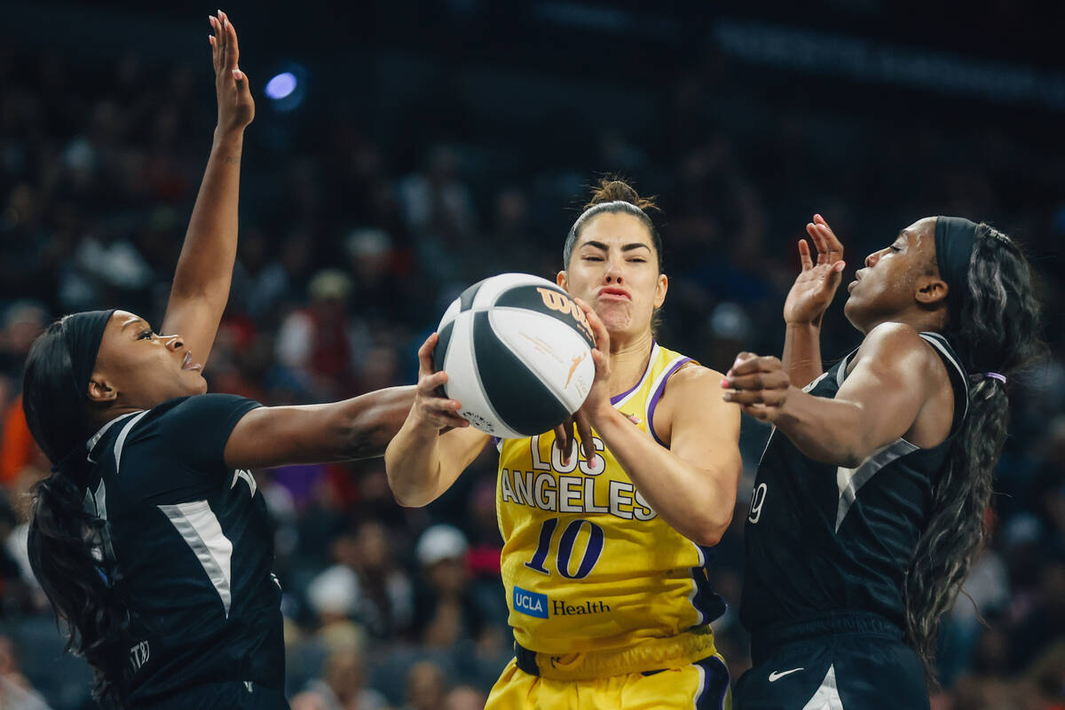 Los Angeles Sparks guard Kelsey Plum (10) is sandwiched by Aces defense during a WNBA basketbal ...