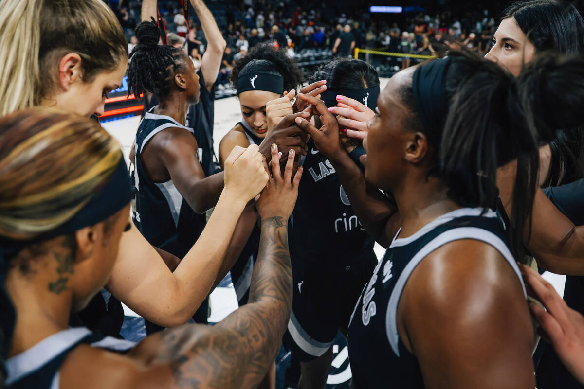Aces players huddle for a brief moment after a loss during a WNBA basketball game between the A ...