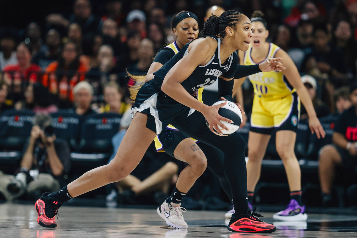 Aces center A'ja Wilson (22) dribbles the ball during a WNBA basketball game between the Aces a ...
