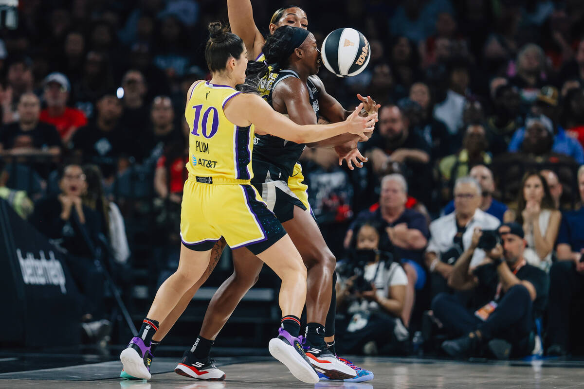 Aces guard Jackie Young (0) gets a ball to the face as Los Angeles Sparks defense narrows in on ...