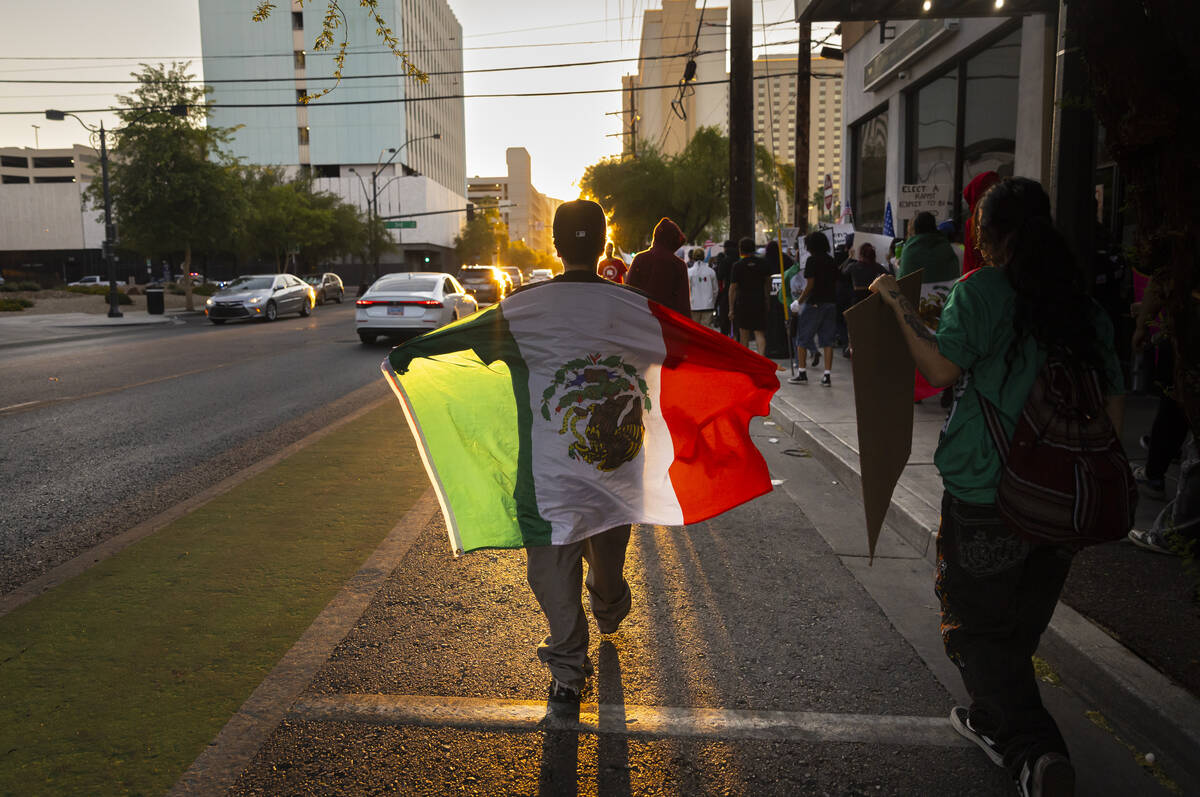 People participate in a protest against ICE on Wednesday, June 11, 2025, in downtown Las Vegas. ...