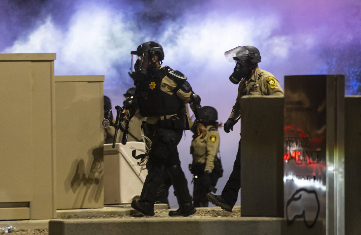 Las Vegas police advance as teargas fills the air during a protest against ICE on Wednesday, Ju ...