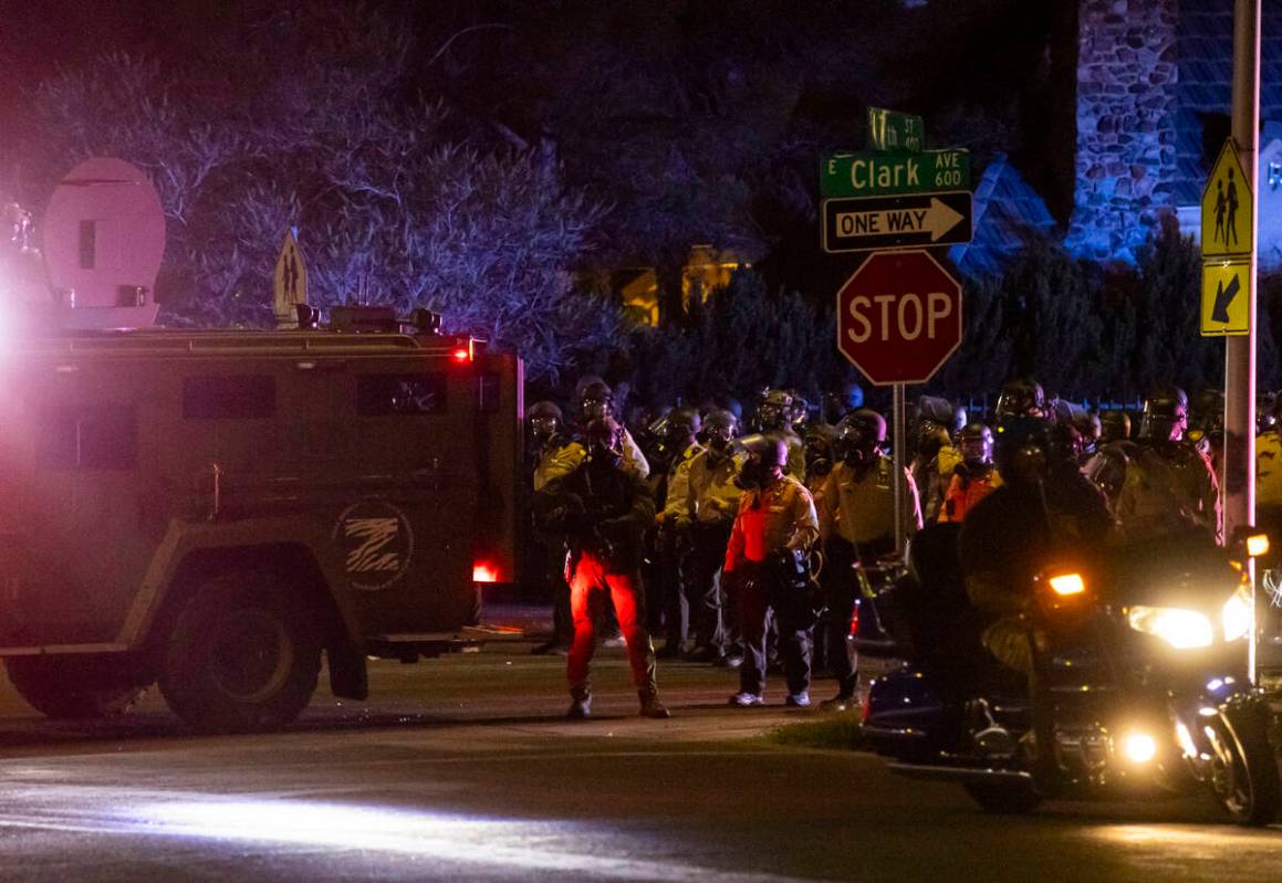 Las Vegas police hold the line after deploying teargas at people protesting against ICE on Wedn ...