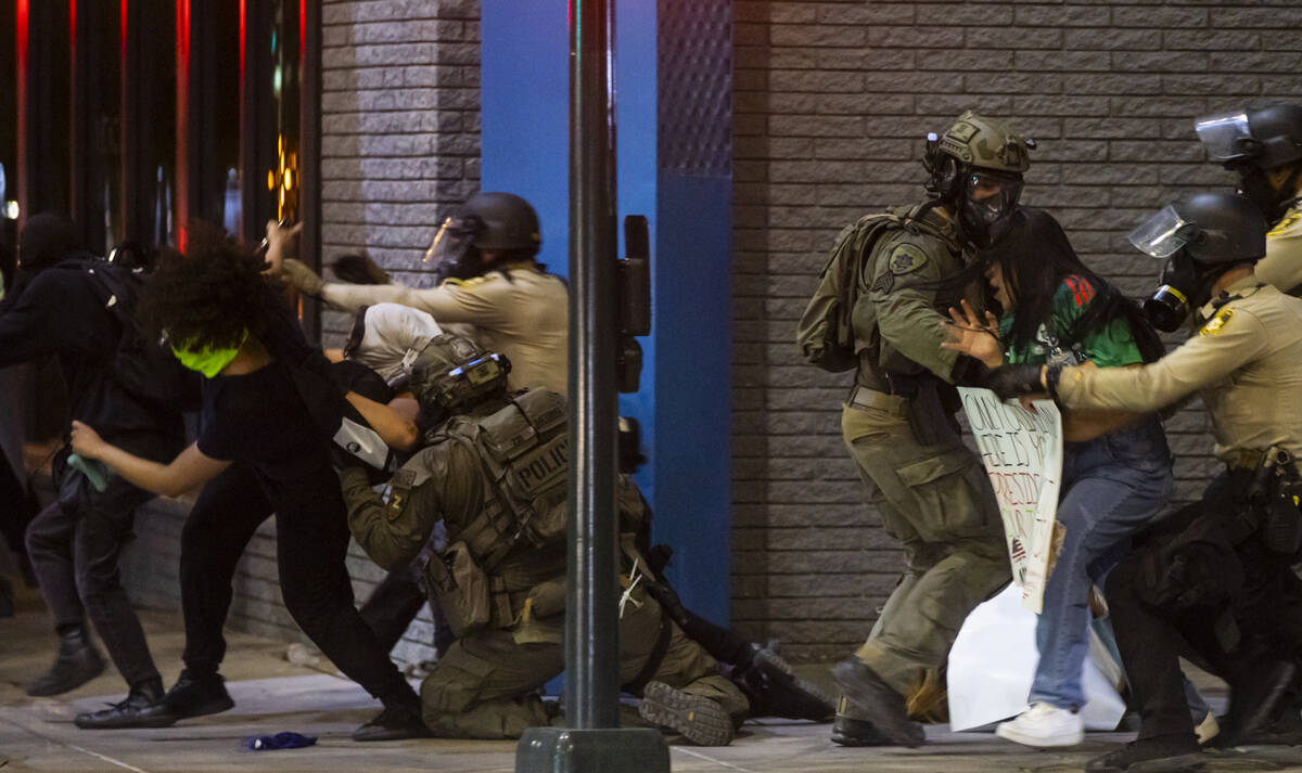 Las Vegas police officers detain people protesting against ICE at Fremont Street and Maryland P ...