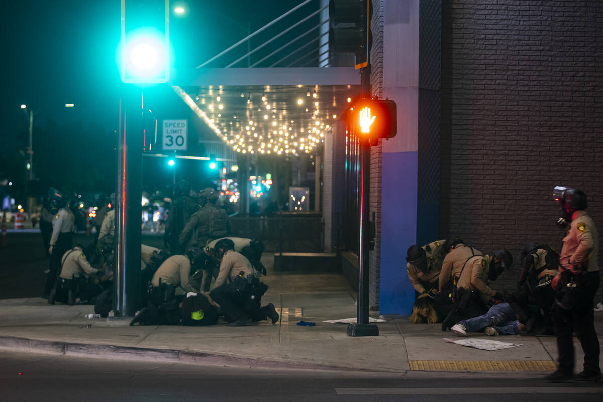 Las Vegas police officers detain people protesting against ICE at Fremont Street and Maryland P ...