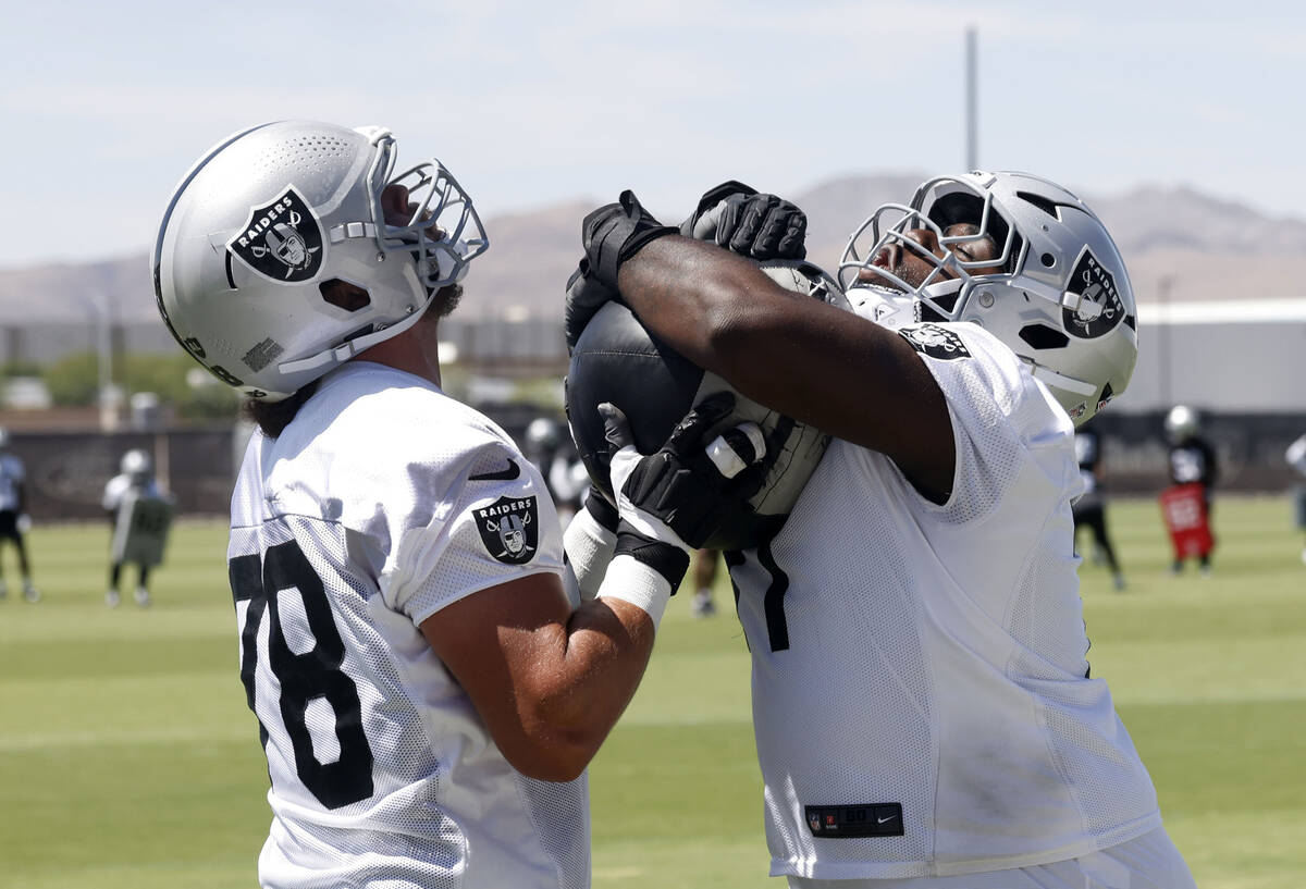 Raiders offensive linemen Dalton Wagner, left, and DJ Glaze (71) work on drills during the last ...