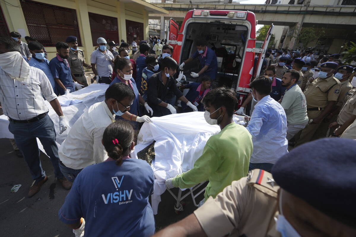 Remains of victims are brought to Civil Hospital after an airplane crashed in India's northwest ...