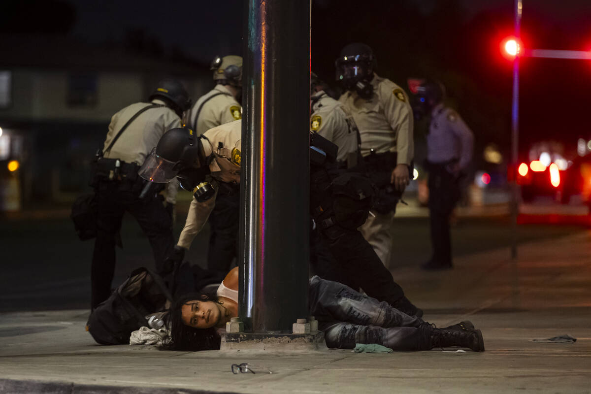Las Vegas police officers detain people protesting against ICE at Fremont Street and Maryland P ...