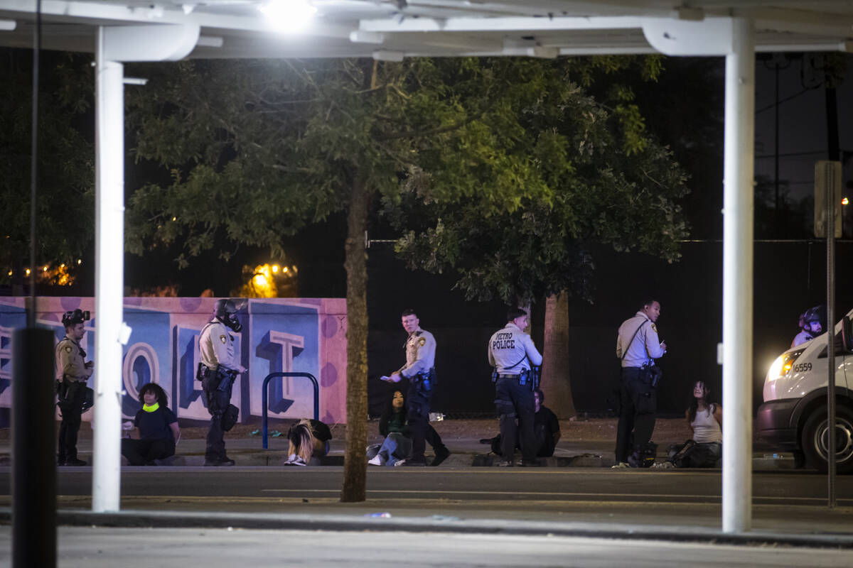 Las Vegas police officers detain and arrest people protesting against ICE at Fremont Street and ...
