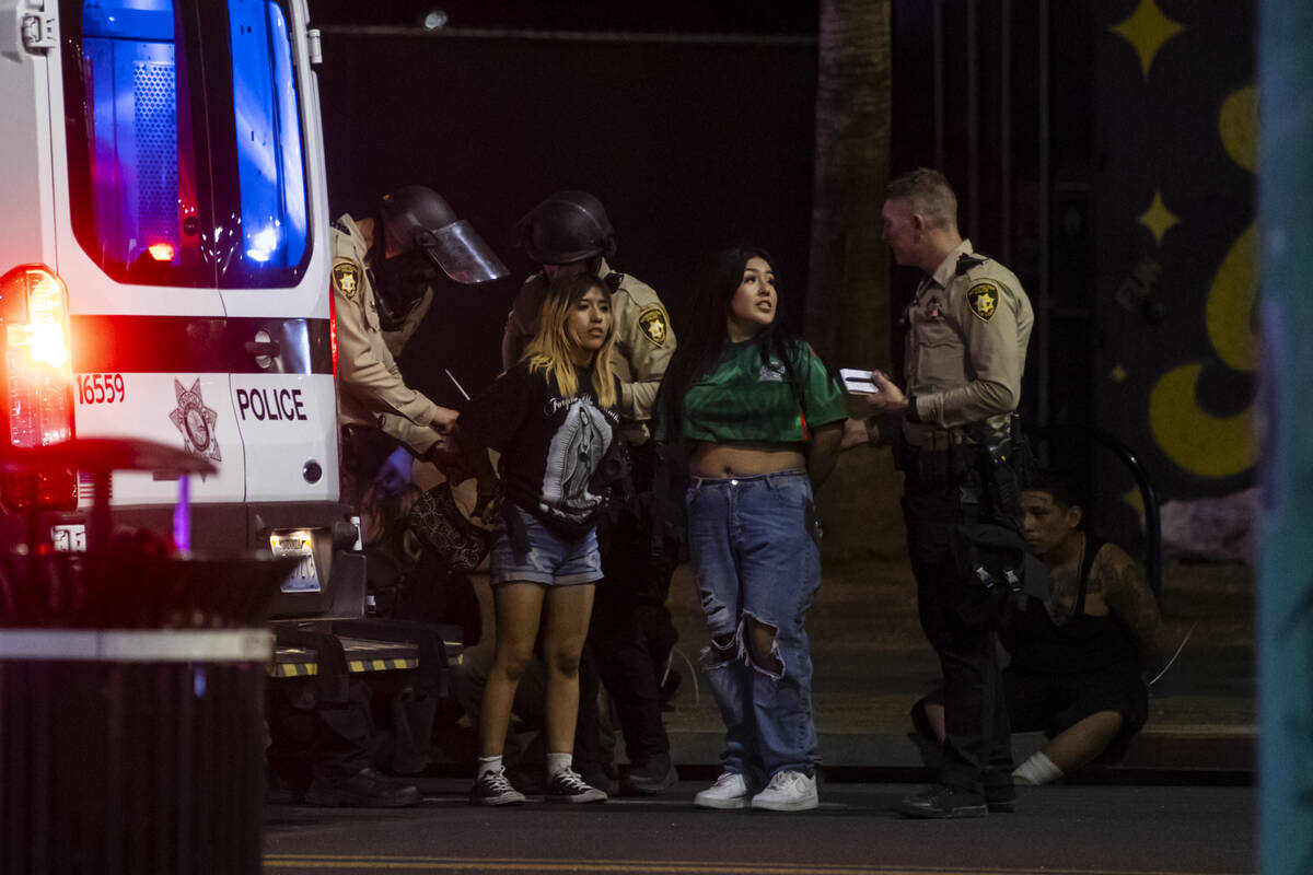 Las Vegas police officers detain and arrest people protesting against ICE at Fremont Street and ...