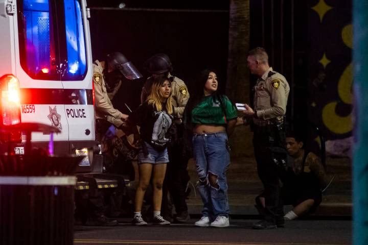 Las Vegas police officers detain and arrest people protesting against ICE at Fremont Street and ...