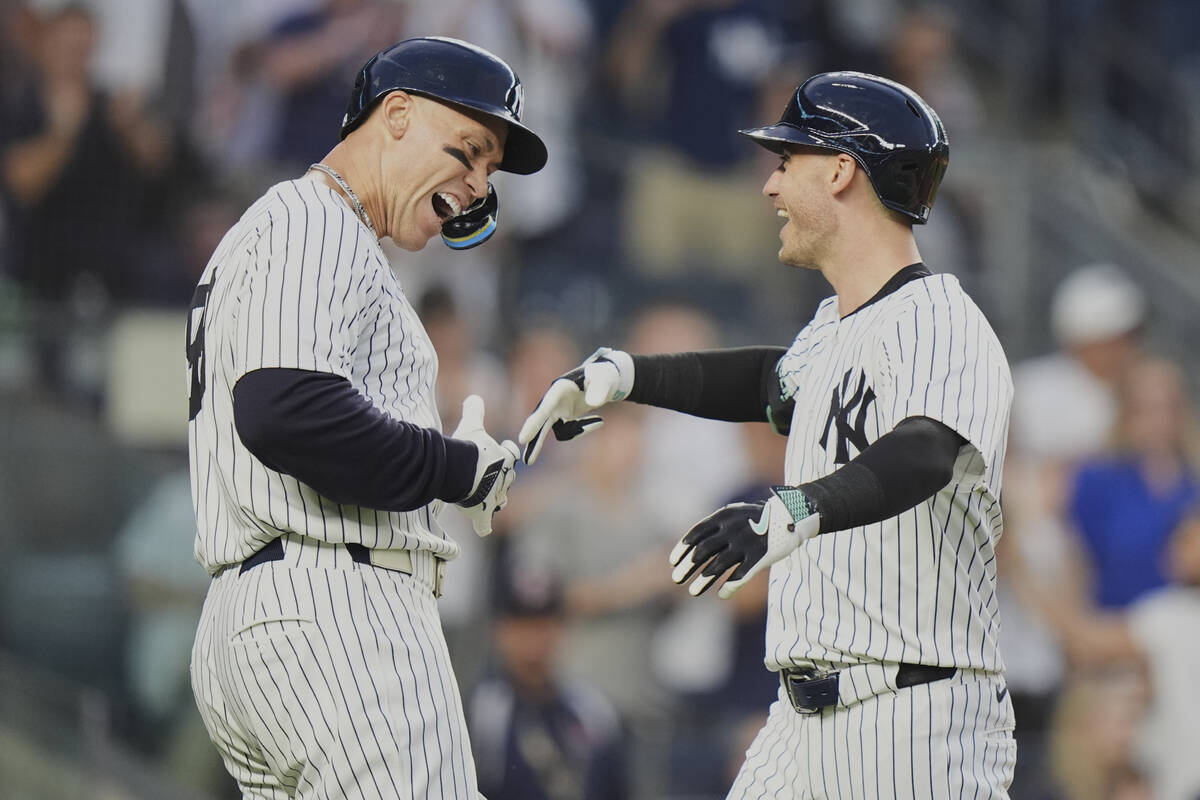 New York Yankees' Aaron Judge, left, celebrates with Cody Bellinger after they scored on a two- ...