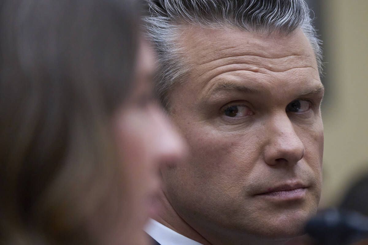 Secretary of Defense Pete Hegseth looks at Bryn MacDonnell, left, acting chief financial office ...