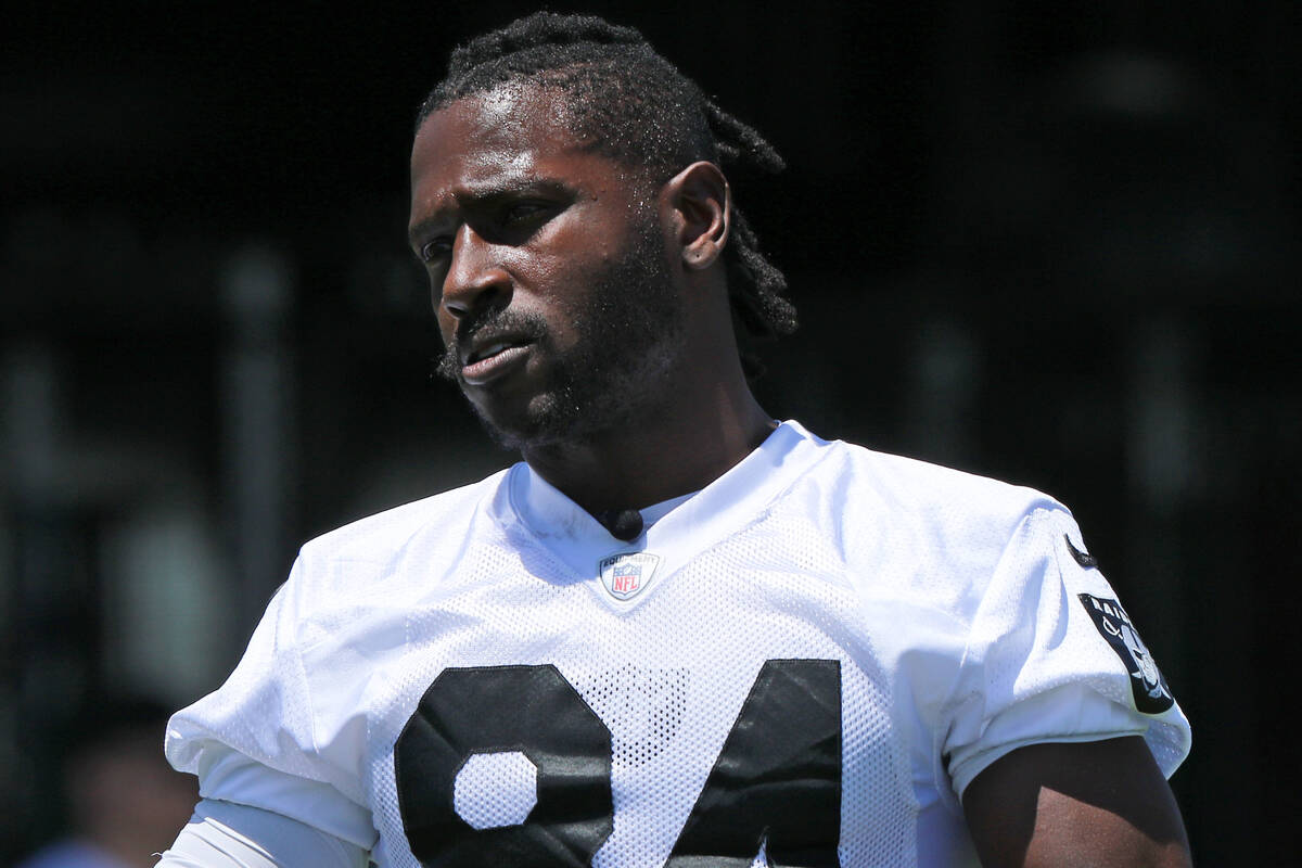 Raiders wide receiver Antonio Brown (84) stretches on the sideline during mandatory minicamp at ...