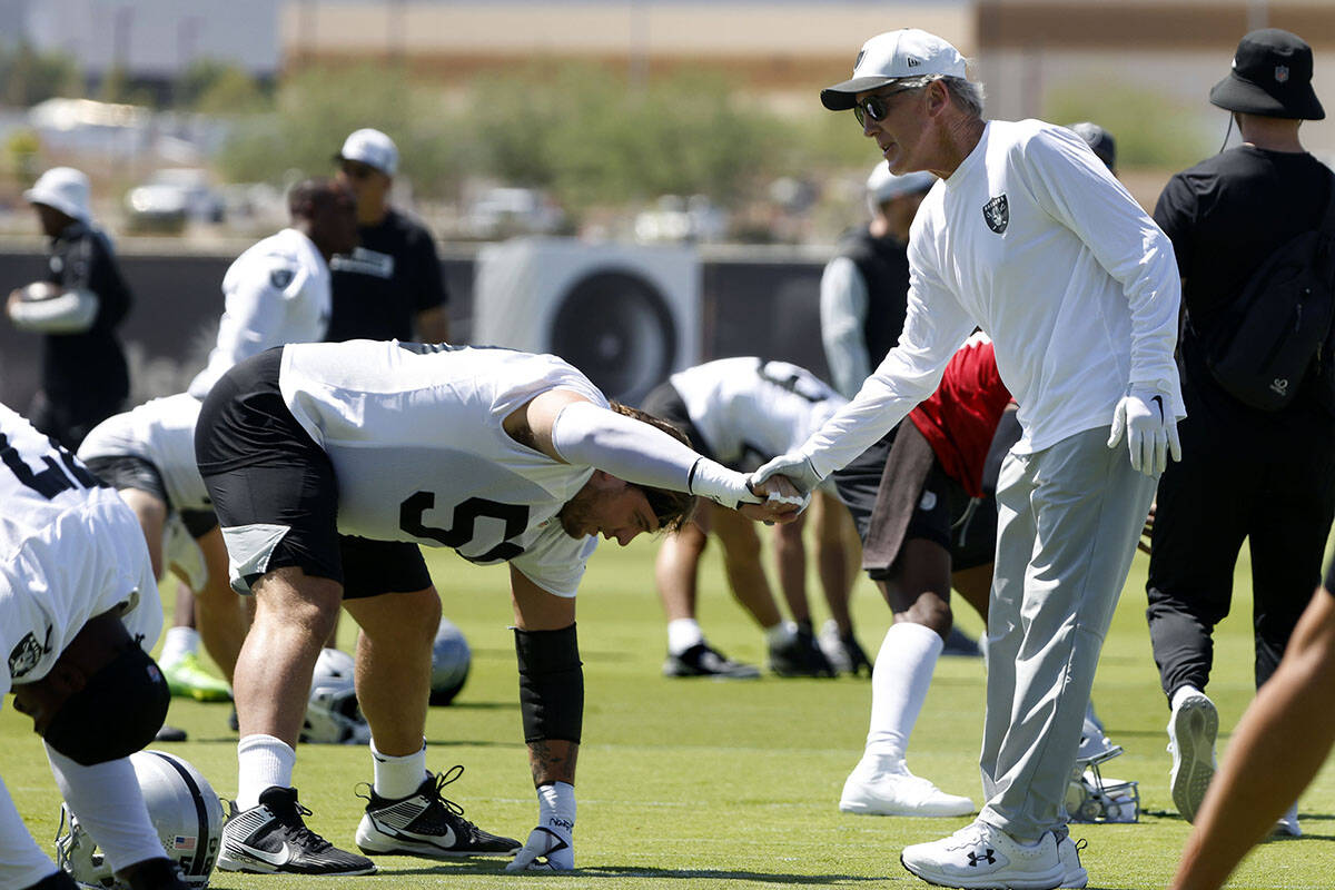 Raiders center Jackson Powers-Johnson (58) shakes hands with head coach Pete Carroll as he stre ...