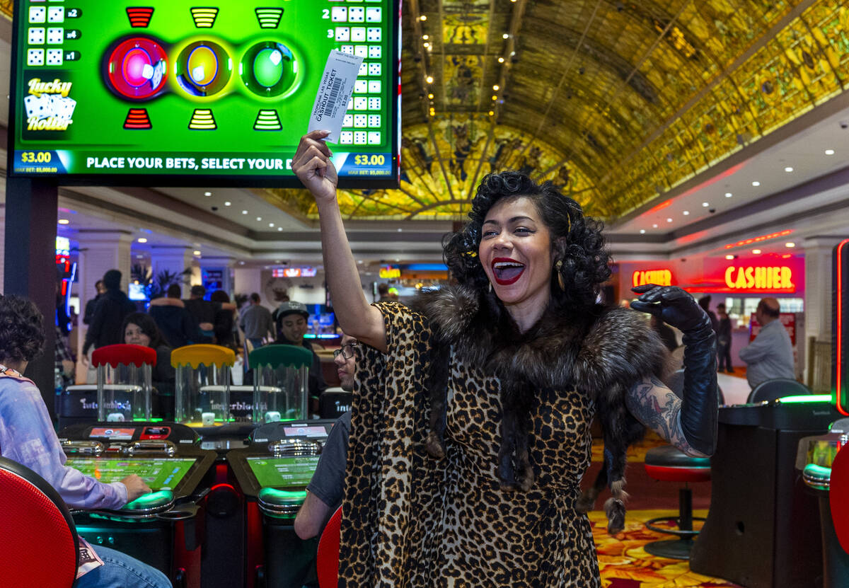 Heather Holliday excitedly waves about a big payout of $2 during the final night of gaming at t ...