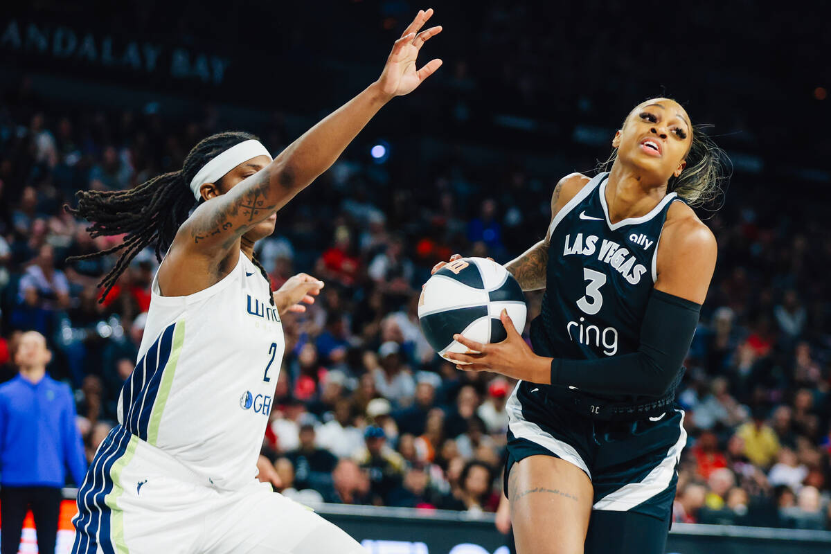 Las Vegas Aces guard Tiffany Mitchell (3) works the ball around Dallas Wings forward Myisha Hin ...