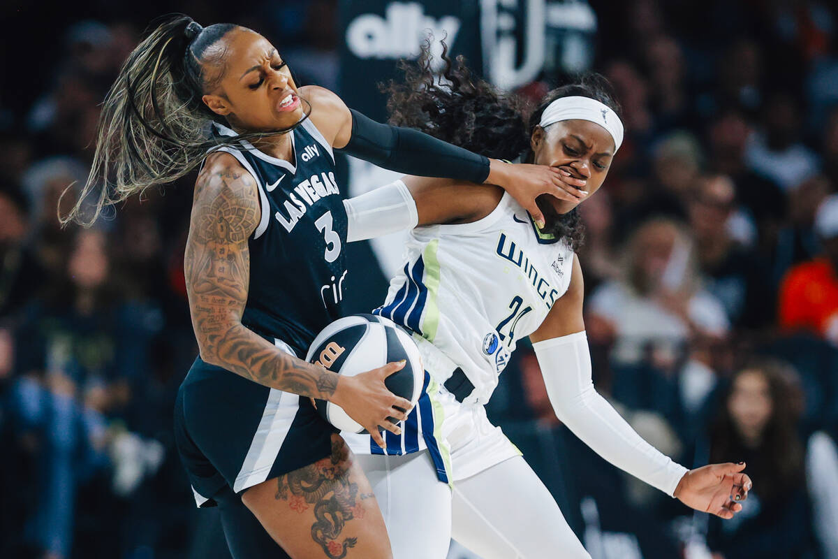 Las Vegas Aces guard Tiffany Mitchell (3) tries to keep away from Dallas Wings guard Arike Ogun ...