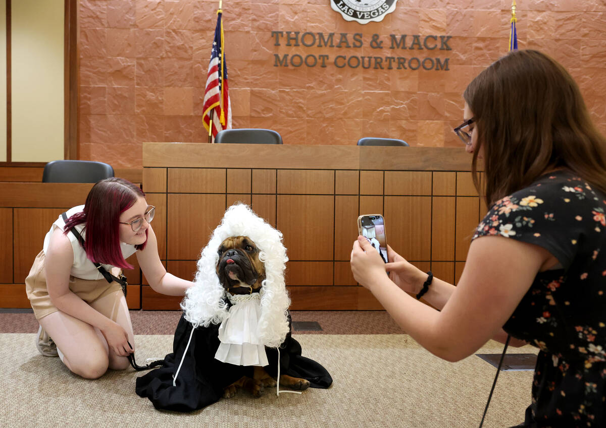 Annika Reeves takes a photo of Hufflepuff, a half-French, half-English bulldog, and Cassie Kirk ...