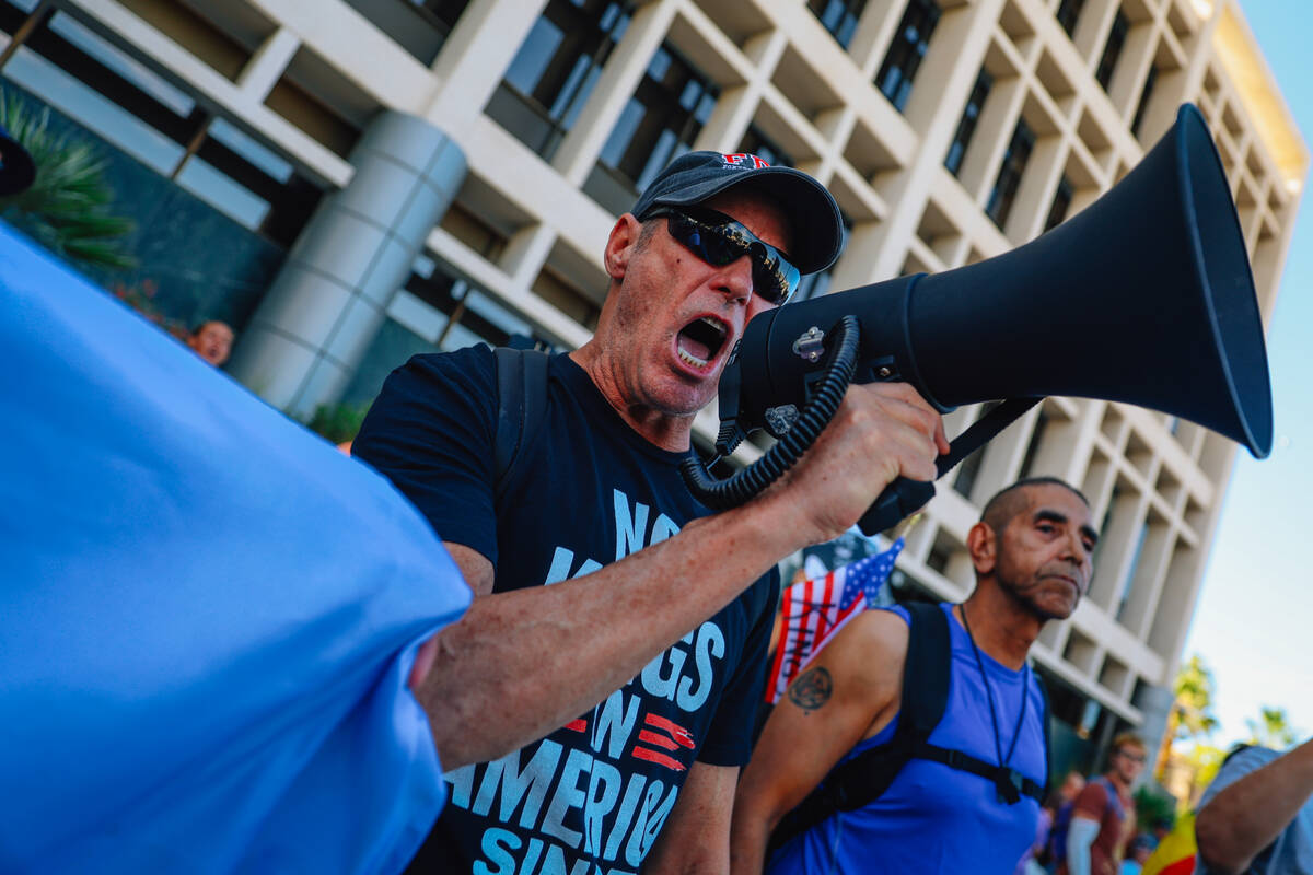 Protesters gather during a national “No Kings” protest in the downtown area Satur ...
