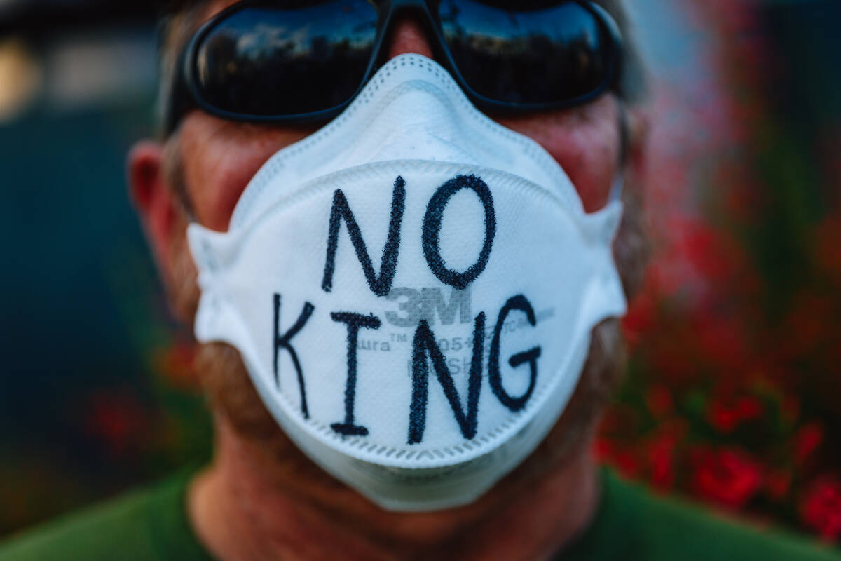 A protestor wears a mask during a “No Kings” protest in the downtown area Saturda ...