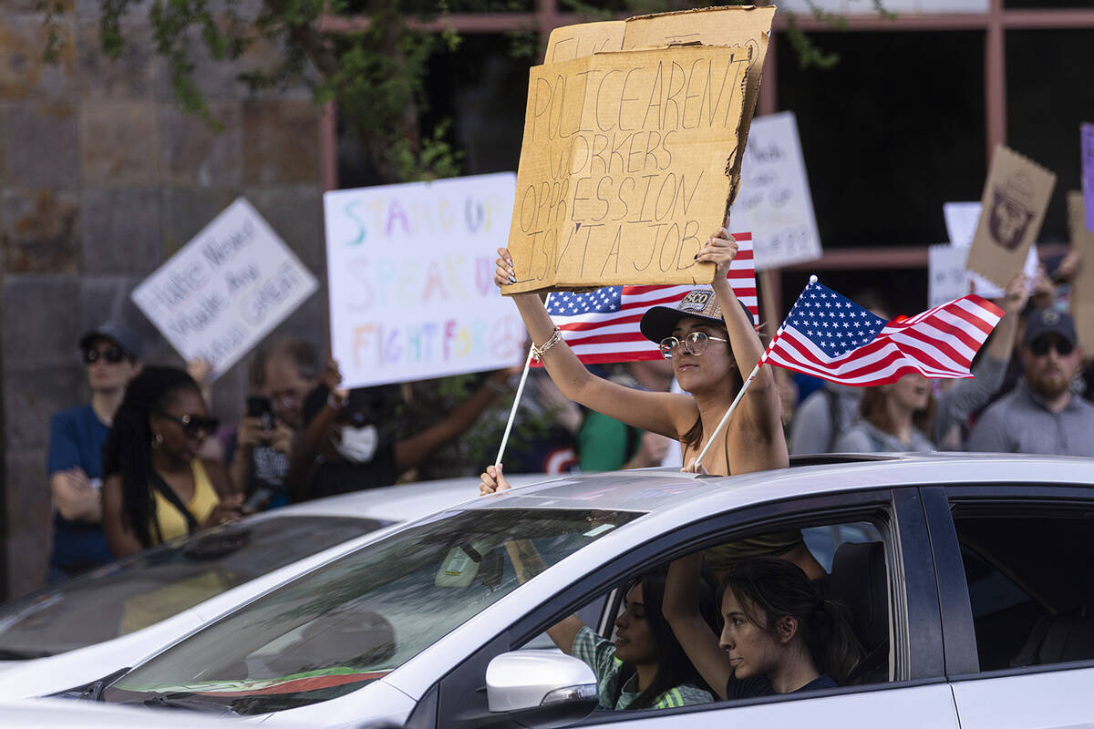 People take part in the “No Kings” protest on Saturday, June 14, 2025, in downtow ...