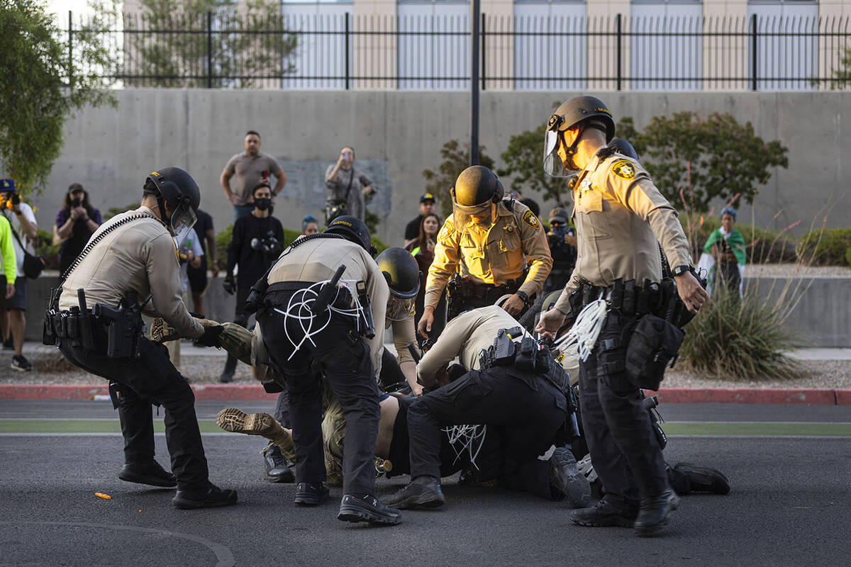 A man is arrested during the “No Kings” protest on Saturday, June 14, 2025, in do ...