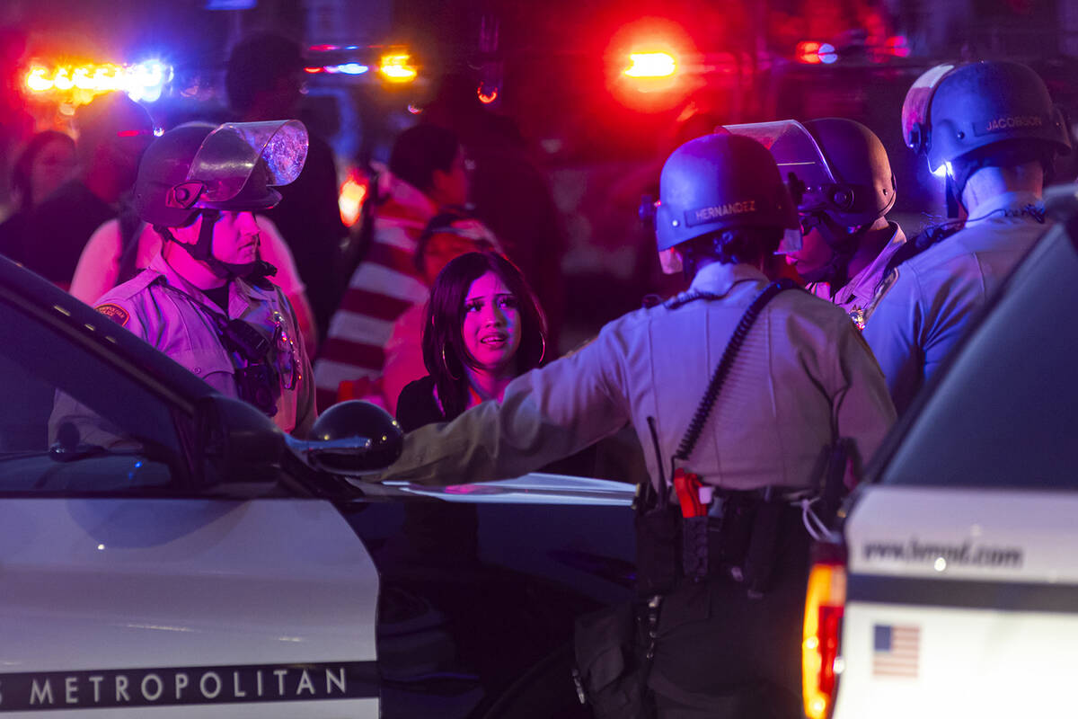 A young woman is detained during the “No Kings” protest on Saturday, June 14, 202 ...