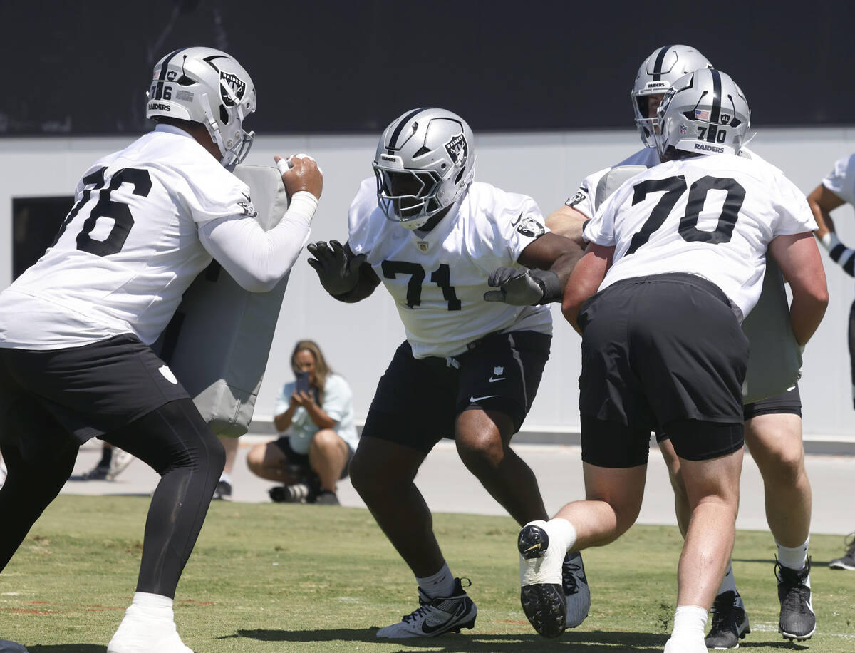 Raiders guard Caleb Rogers, left, and offensive linemen DJ Glaze (71) and Parker Clements (70) ...