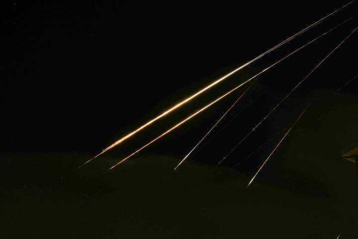 Traces of projectile illuminates the sky seen from northern Israel, Saturday, June 14, 2025. (A ...