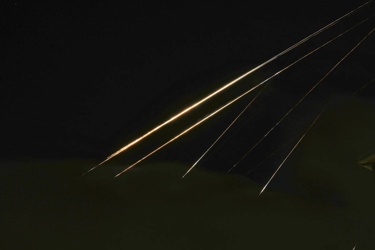 Traces of projectile illuminates the sky seen from northern Israel, Saturday, June 14, 2025. (A ...