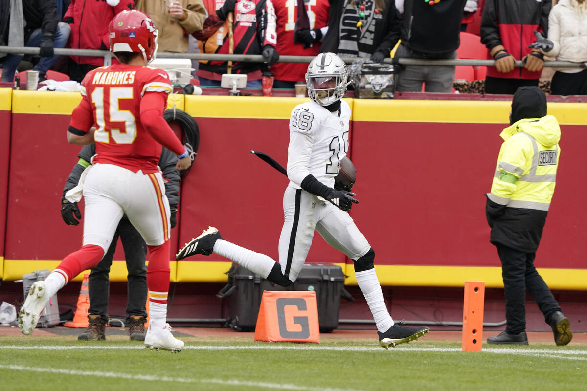 Las Vegas Raiders cornerback Jack Jones scores after intercepting a pass and running it back fo ...