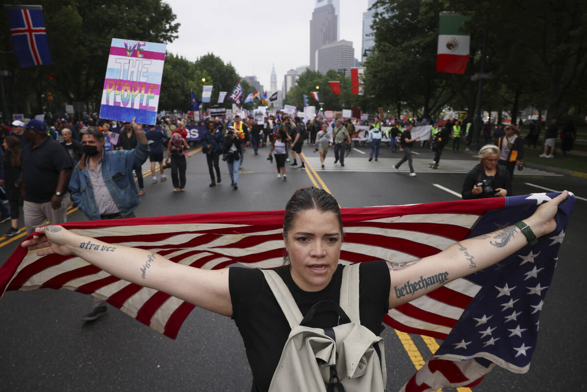 Demonstrators march down Benjamin Franklin Parkway during the "No Kings" protest, Sat ...