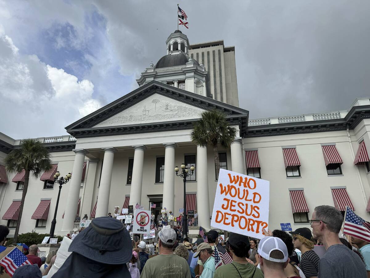 People gather on the grounds of Florida’s old capitol in Tallahassee, Fla., for &#x201c ...