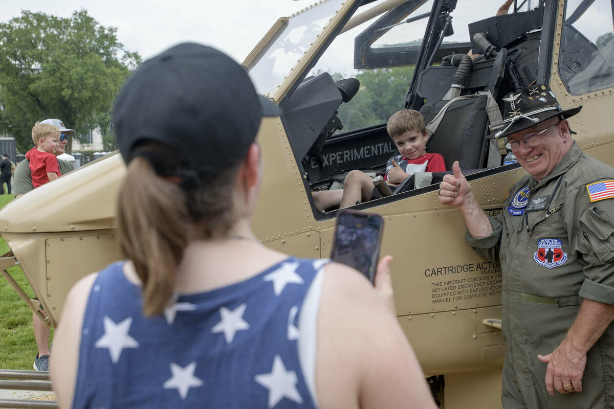 Retired Army CW4 Floyd Werner Jr., right, poses with Victor Koza, 5, center, as his mother, Mel ...