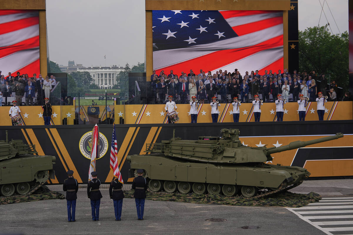 The National Anthem is performed as President Donald Trump attends a military parade commemorat ...