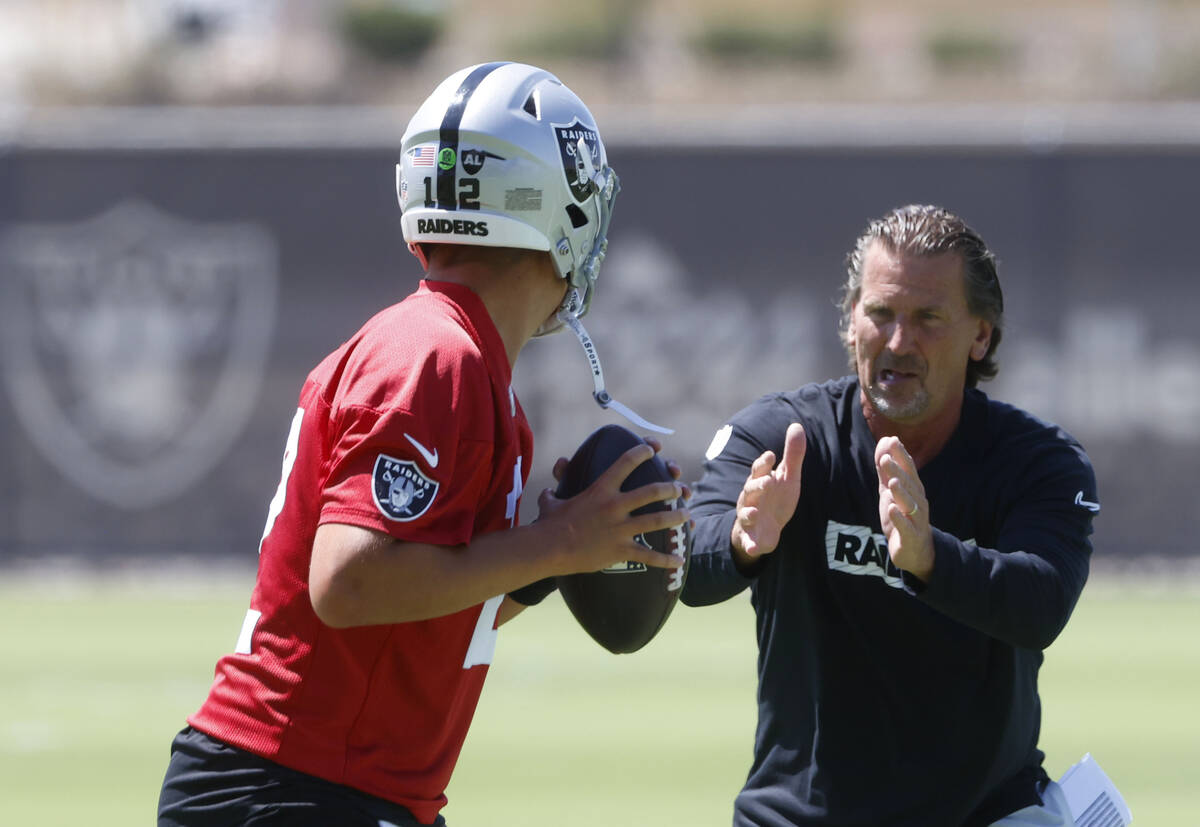 Raiders quarterback Aidan O'Connell (12) works with quarterback coach Greg Olson during an NFL ...
