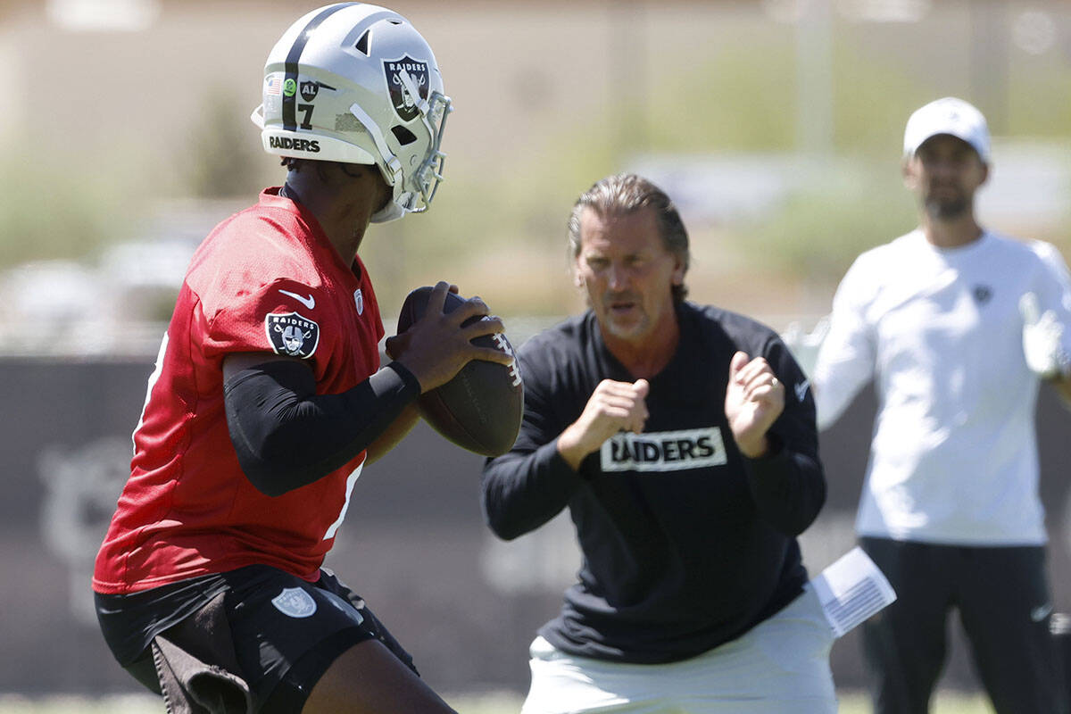 Raiders quarterback Geno Smith (7) works with quarterback coach Greg Olson during an NFL mandat ...