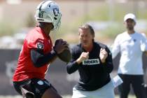 Raiders quarterback Geno Smith (7) works with quarterback coach Greg Olson during an NFL mandat ...
