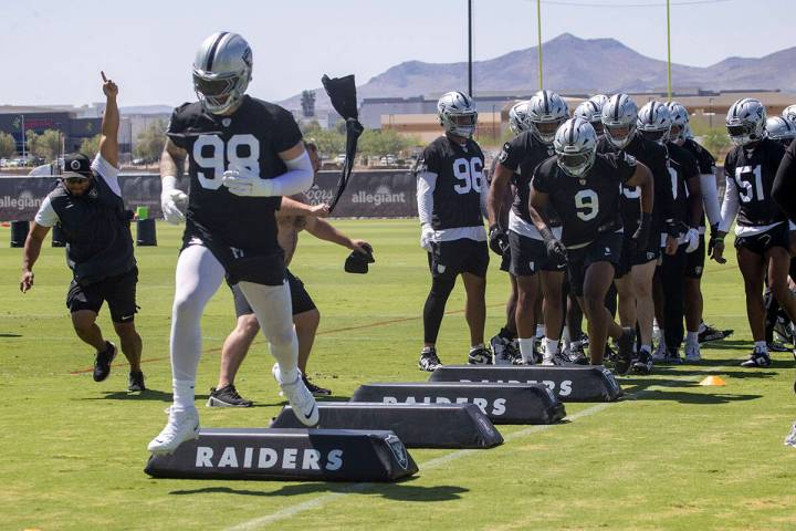 Raiders defensive end Maxx Crosby (98) leads the team during a drill as Raiders defensive end T ...