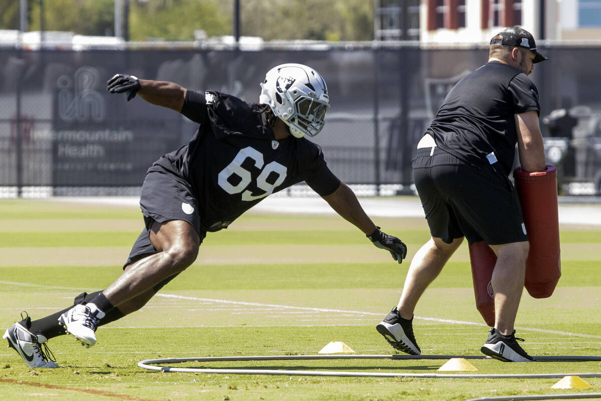 Raiders defensive tackle Adam Butler (69) launches himself towards a tackle post during an NFL ...