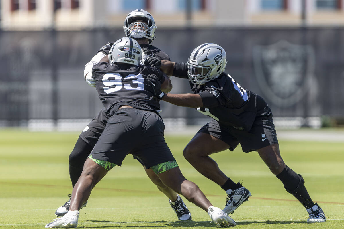 Raiders defensive tackle Adam Butler (69), right, works against defensive tackle Zach Carter (9 ...