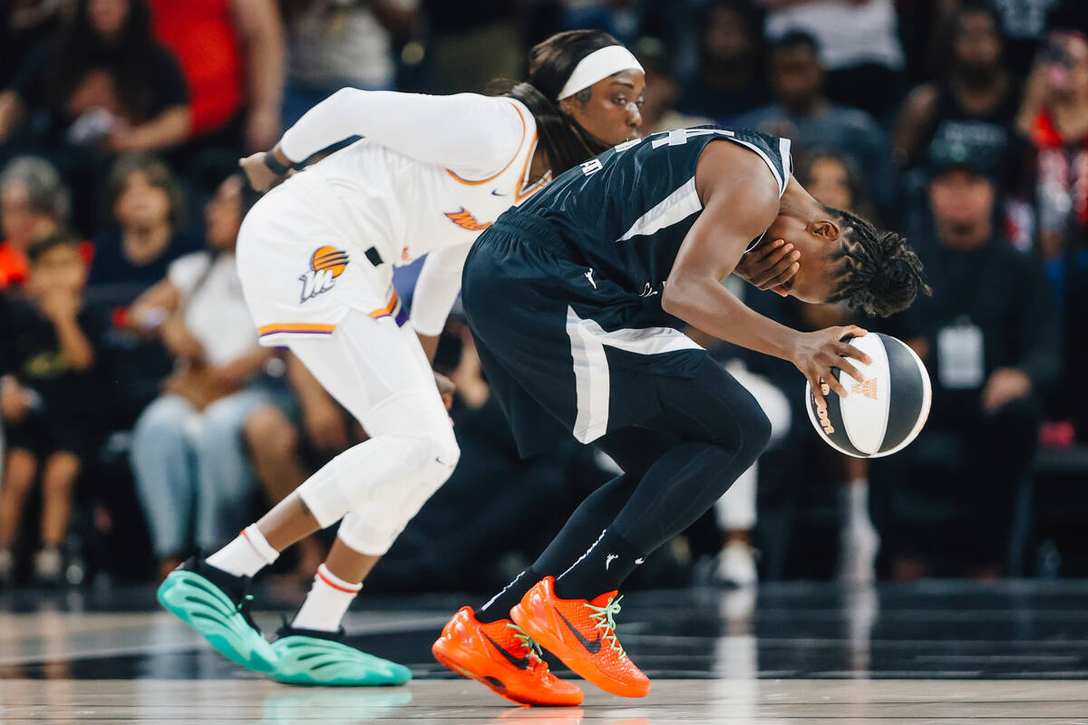 Aces guard Jewell Loyd (24) cradles her eye after contact from Phoenix Mercury guard Kahleah Co ...