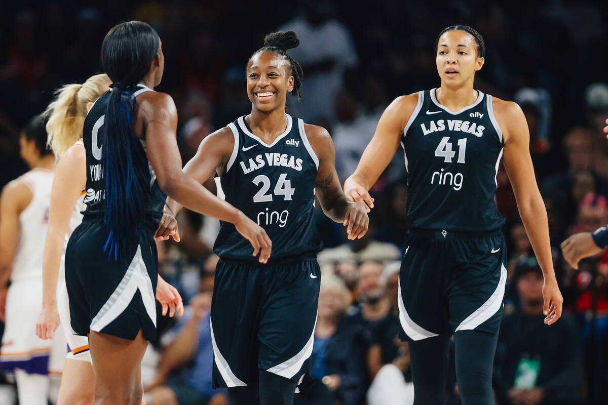 Aces guard Jewell Loyd (24) smiles at Aces guard Jackie Young (0) after Young drew a foul durin ...