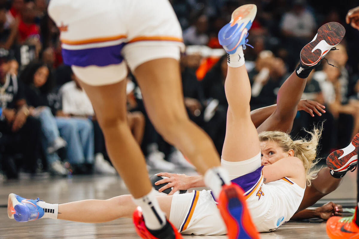 Phoenix Mercury guard Lexi Held (1) eyes a teammate after wrestling for the ball during a WNBA ...