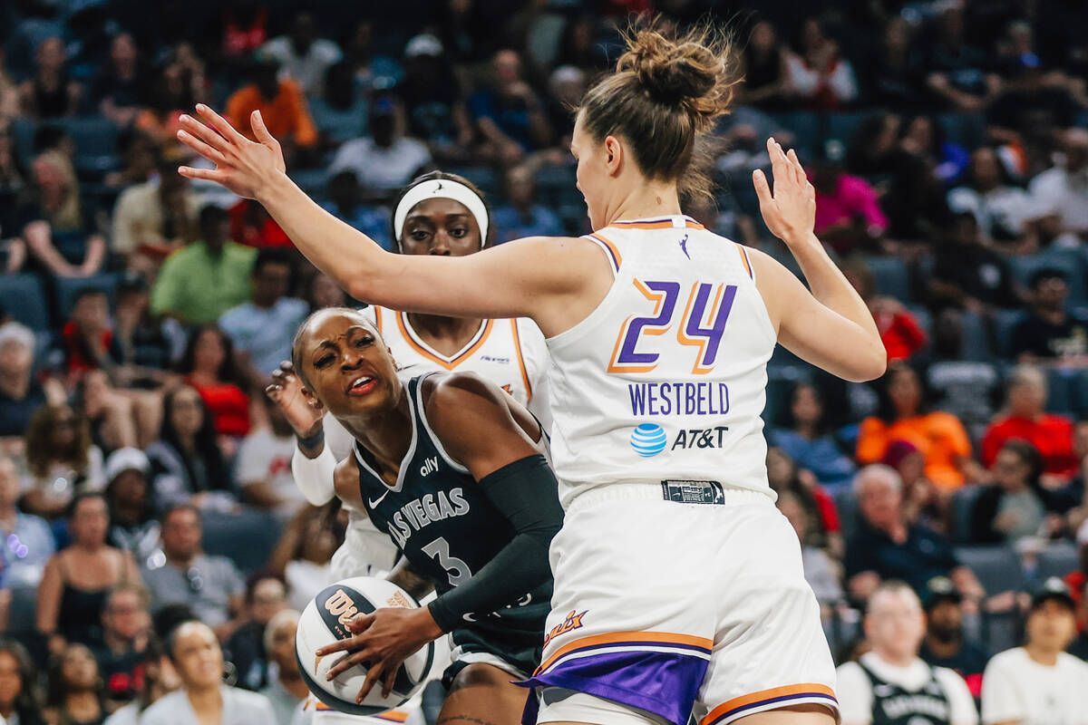 Aces guard Tiffany Mitchell (3) drives the ball between Phoenix Mercury defense during a WNBA b ...