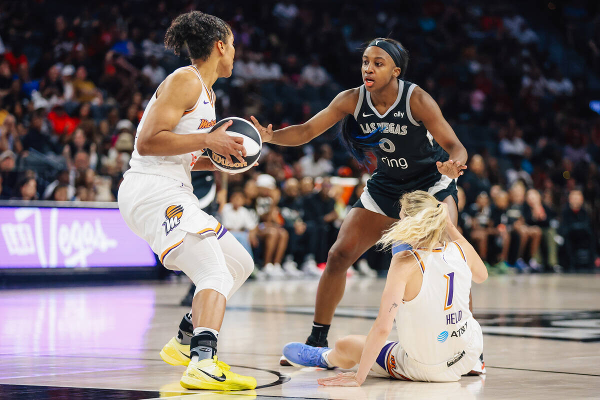 Aces guard Jackie Young (0) guards Phoenix Mercury forward Alyssa Thomas (25) during a WNBA bas ...