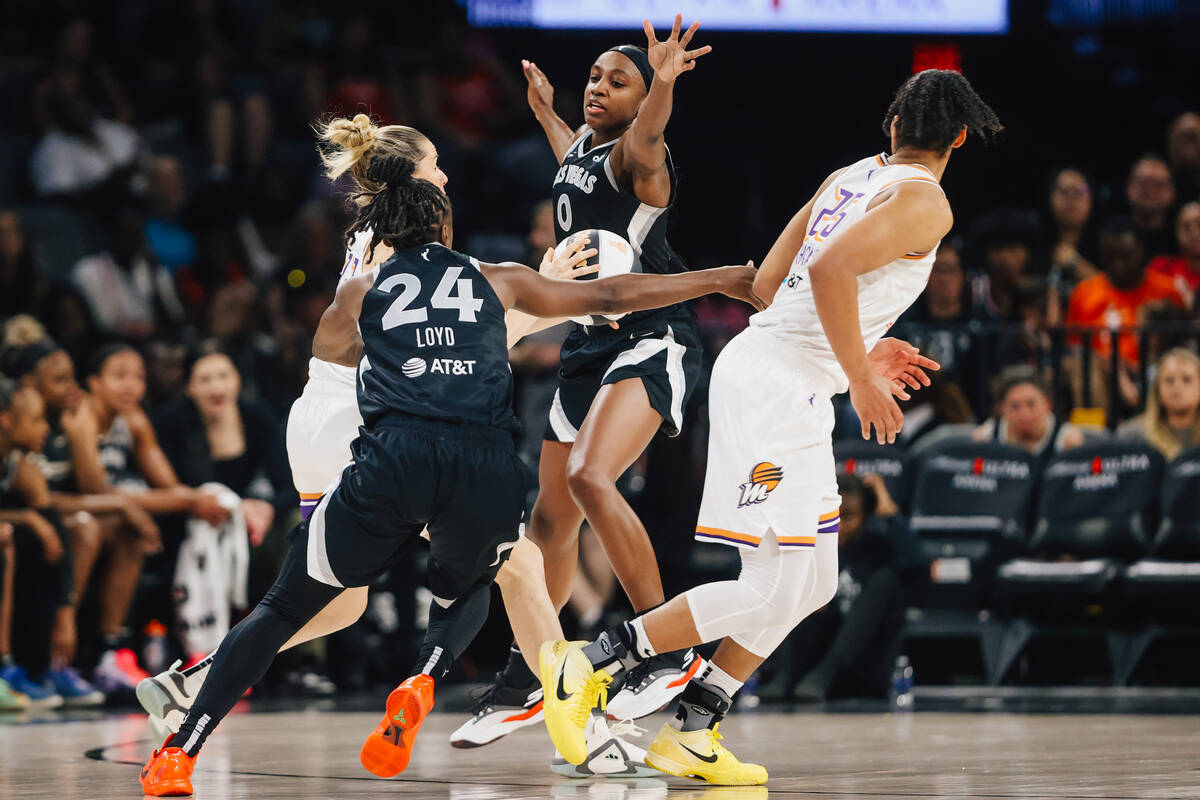 Aces guard Jackie Young (0) defends during a WNBA basketball game between the Aces and Phoenix ...