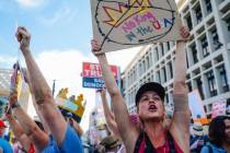 Protestors shout during a national “No Kings” protest in the downtown area Saturd ...