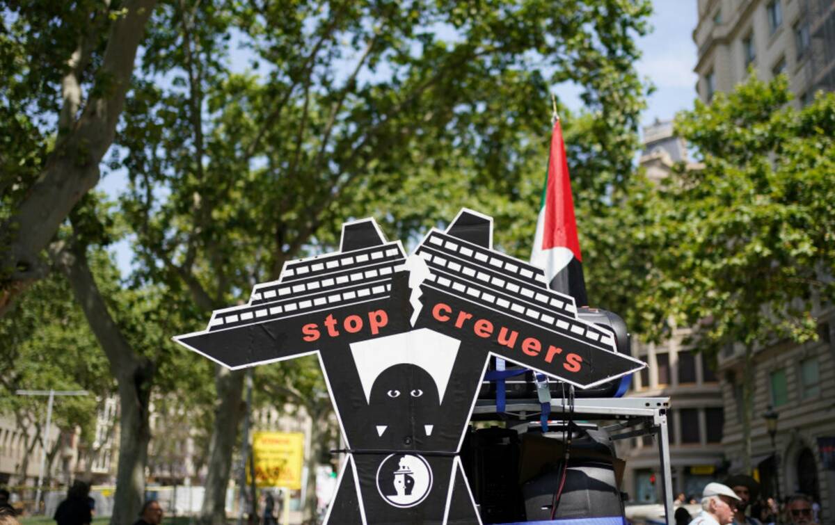 A cardboard figure of a cruise ship is photographed during a protest against overtourism in Bar ...